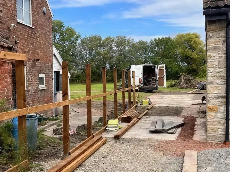 Posts and rails up along the drive, the van parked beyond