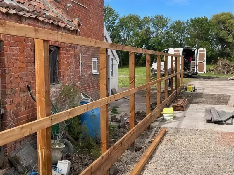 Rails fixed to the posts against a brick wall