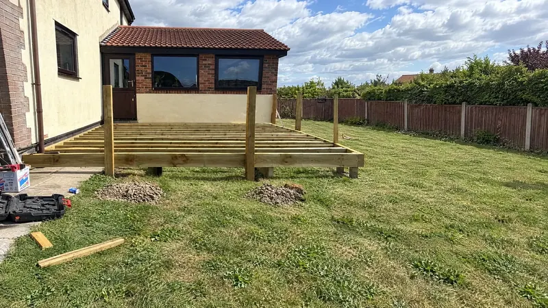A raised timber deck frame set out level on a lawn