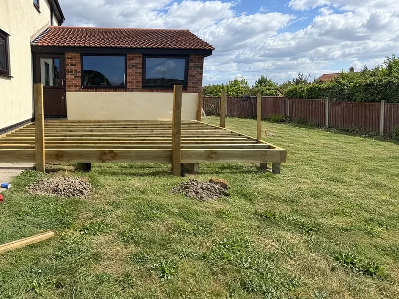 A raised timber deck frame set out level on a lawn