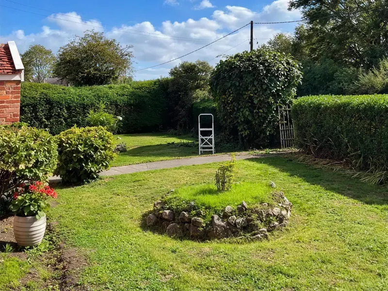 A tidied garden with the grass cut and the borders cleared